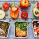 a variety of foods in plastic containers, showcasing healthy options for a nutrition course