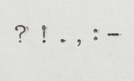 punctuation marks typewritten on white paper