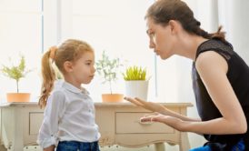 mom wearing black top scolding young daughter