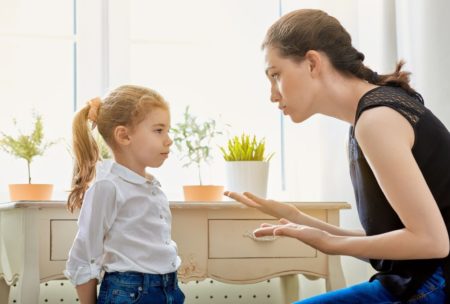 mom wearing black top scolding young daughter