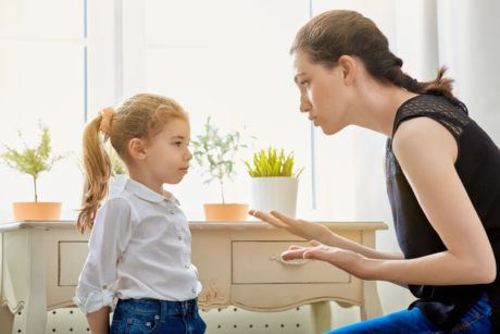 mom wearing black top scolding young daughter
