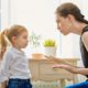 mom wearing black top scolding young daughter