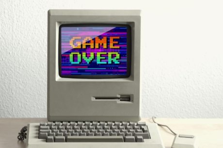 desktop computer with words game over on display