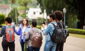 female tour guide talking to a group of young people