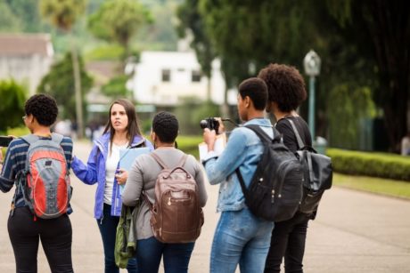 female tour guide talking to a group of young people
