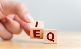 wooden letter cubes showing the words iq and eq