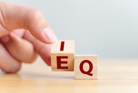 wooden letter cubes showing the words iq and eq