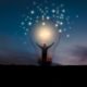 man standing inside giant light bulb