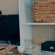 woman wearing white top writing on desk