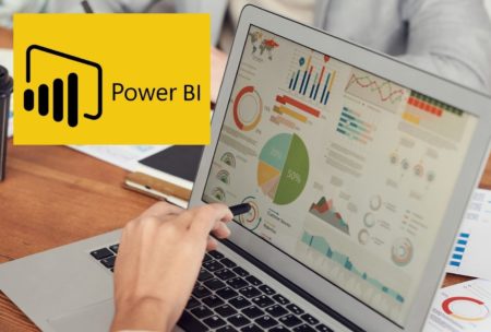 power bi logo and person creating chart on laptop