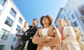 team of corporate people looking up the sky