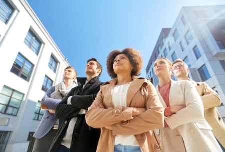 team of corporate people looking up the sky