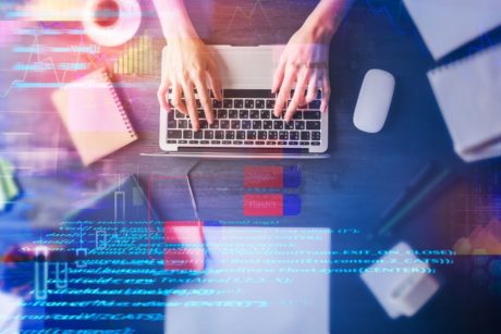 programmer hands typing on laptop