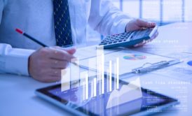 man in white shirt and tie computing cash flow