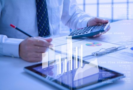 man in white shirt and tie computing cash flow