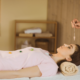 practitioner performing crystal healing on female patient
