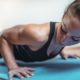 woman doing push ups on blue mat