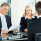 ceo and hiring manager interviewing a male job applicant in black suit