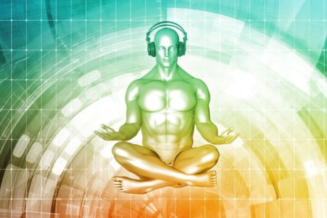 man sitting down meditating and listening to music