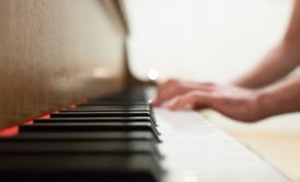 close up of person playing the piano