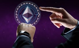 man in black suit pointing at ethereum symbol