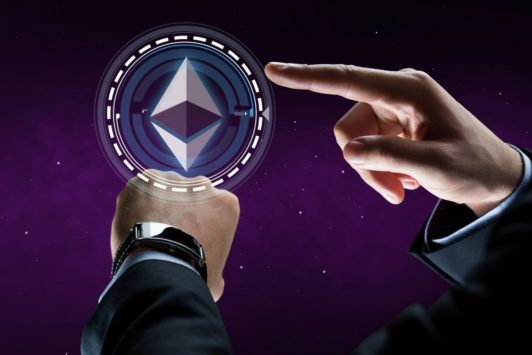 man in black suit pointing at ethereum symbol