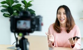 woman in pink top recording an online course