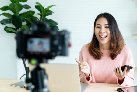 woman in pink top recording an online course