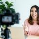 woman in pink top recording an online course