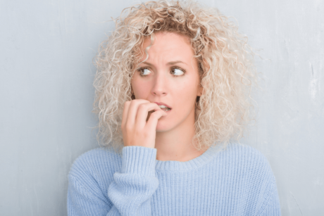 woman with anxiety biting her nails