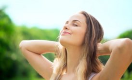 happy woman looking up at the sky