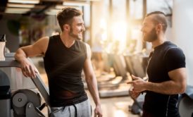 two men working out talking together