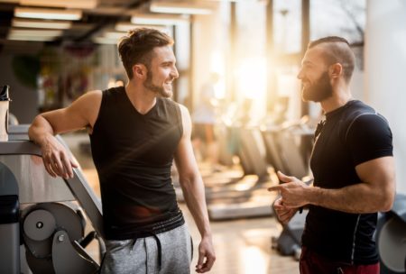 two men working out talking together