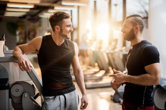 two men working out talking together