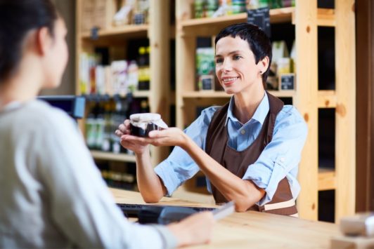 salesperson selling product to female customer