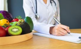 nutritionist and plate of fruits