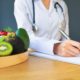 nutritionist and plate of fruits