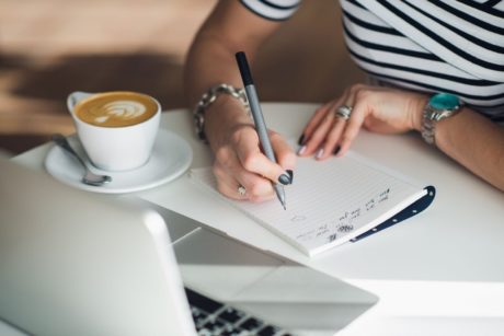 sales person writing script on notepad