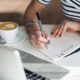 sales person writing script on notepad