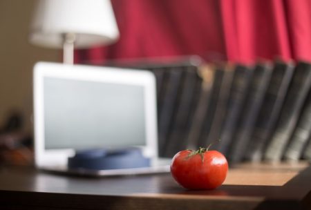 white laptop books and tomato