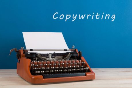 typewriter against blue background copywriting