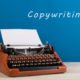 typewriter against blue background copywriting