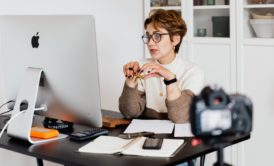 online teaching expert sitting on desk and using computer