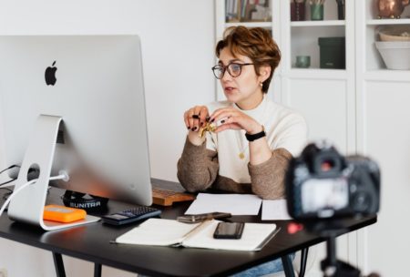 online teaching expert sitting on desk and using computer