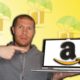 man holding laptop with amazon logo