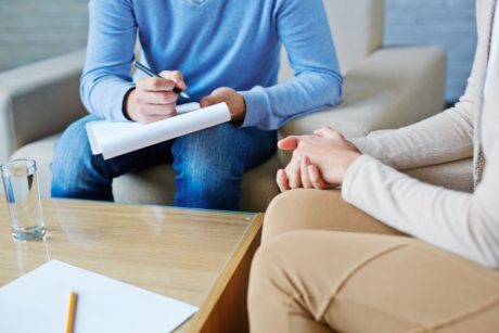 professional counselor talking to patient with addiction