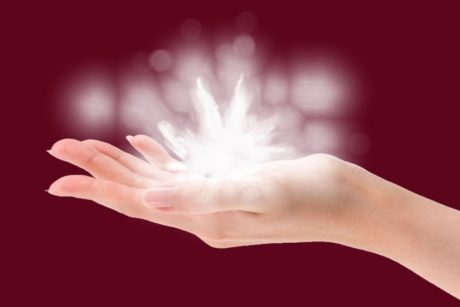 woman's palm holding a glowing lotus