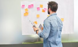 man plotting customer journey and evaluating business idea