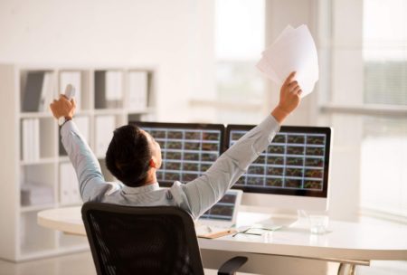 entrepreneur raising hands celebrating success