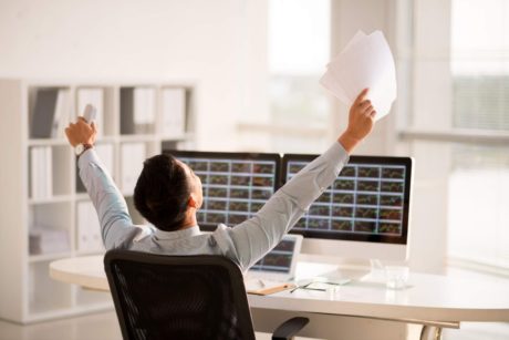 entrepreneur raising hands celebrating success